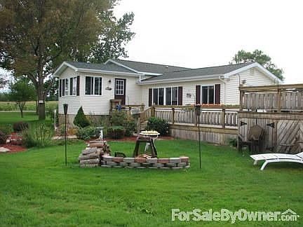 Back Yard : Portion of back yard showing deck area, pool, new all season room.