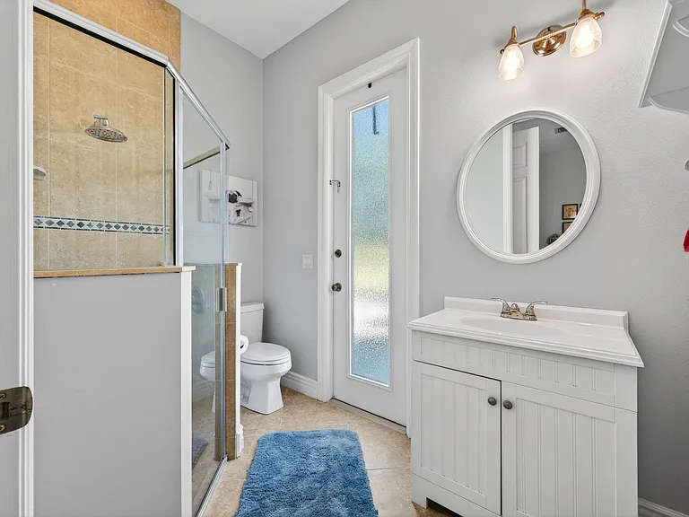 Bathroom off of one of the bedrooms that also connects to the pool area