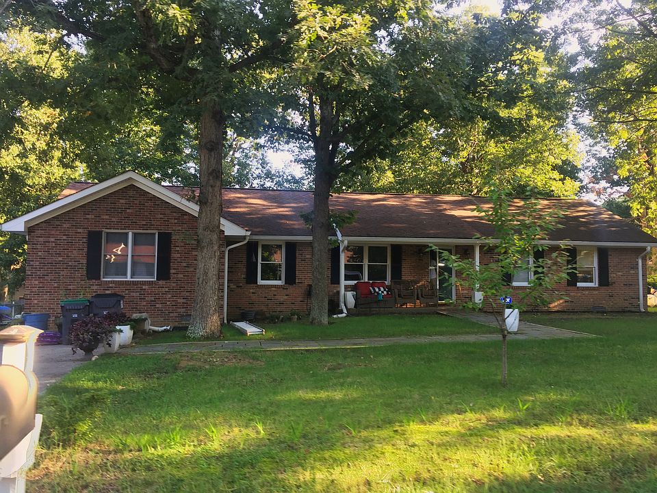 Front of the home with parking on the driveway for 2-3 cars and parking in front of the home. There's a front porch.