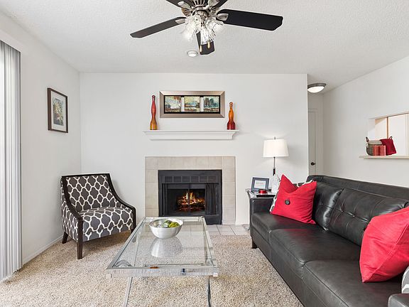 Living Room View with Fireplace and Ceiling Fan - The August
