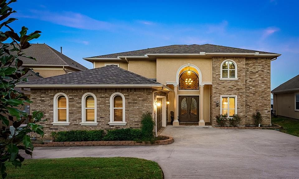 Beautiful custom home on open water with several features including new roof, full house generator, full guest quarters, and more!