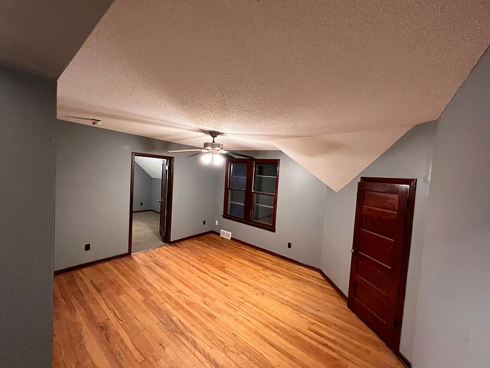 Living room facing door to second bedroom and door to attic bedroom