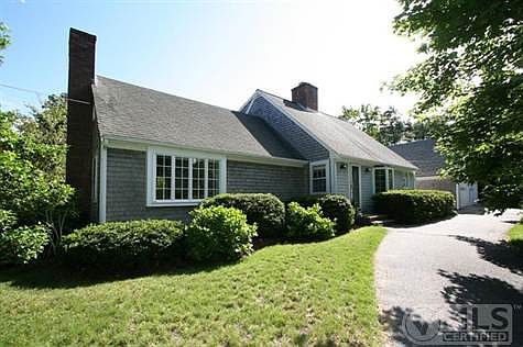 The home sits on a nice rise, slightly elevated from the street. A semi-circular drive arcs from the lane to the house/garage and back.