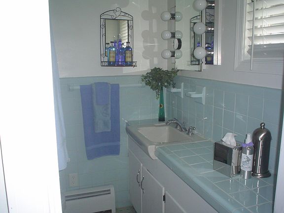 Master Bathroom: shower, sink, toilet, make-up mirror.
