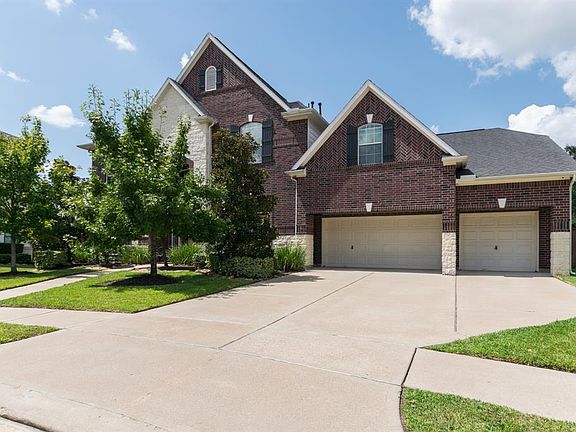 Home features beautiful landscaping, extra wide driveway and three car garage.