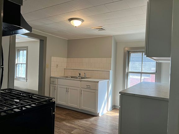 Nice finishes. Wood plank look floors, tile backsplash and marble look countertop