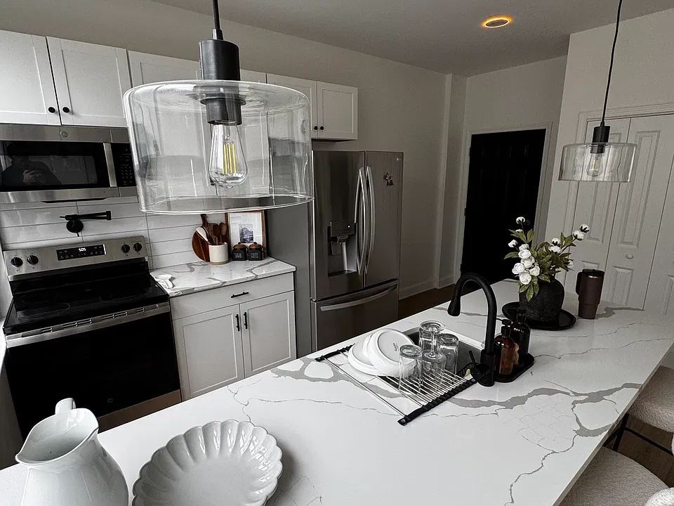 Full-size kitchen appliances, a refrigerator with an ice maker, and pot filler above the stove.