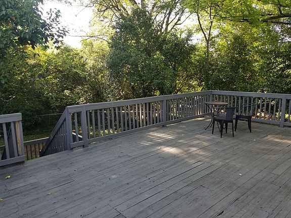Giant shaded deck, stairs to back yard. Substantial basement storage