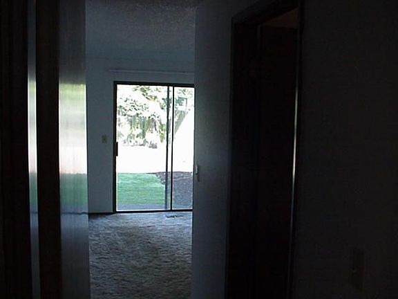 Hallway & closet looking into master bedroom with its own patio & sliding door