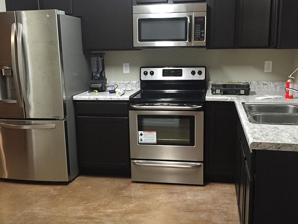 Kitchens have black or stainless appliances as shown