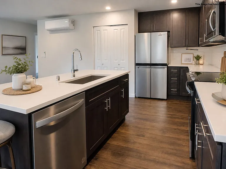 Chef's kitchen with pantry and mini-split which provides air conditioning, virtually staged.