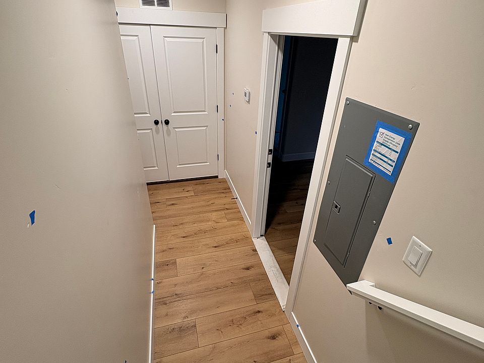 Unit entrance at foot of tenant stairs (open door)