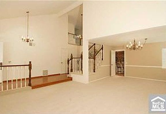 living room view of entry and doorway to kitchen