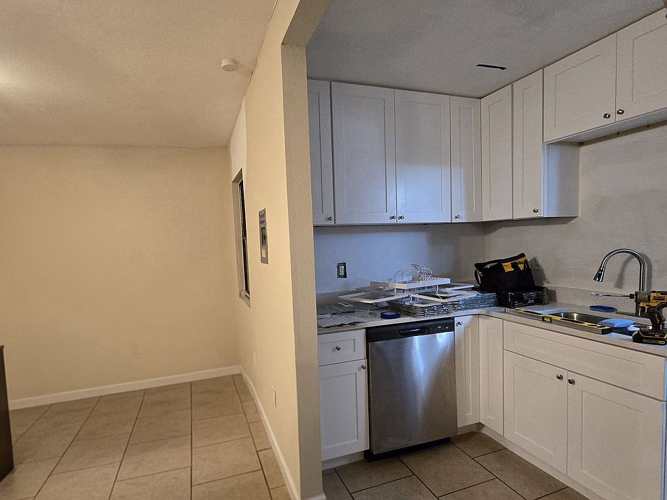 New kitchen light installed since photo was taken, backsplash being installed, window in photo will become a doorway to an additional window (for an additional cost) if the tenant closes to increase square footage.