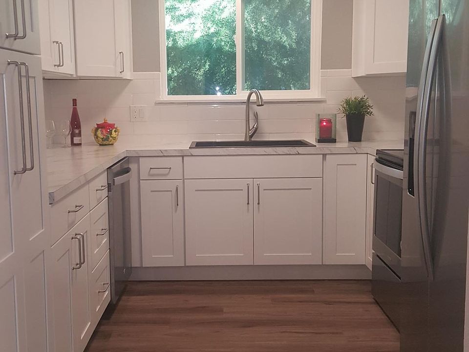 Light, bright kitchen with a window right above your sink looking out on nature.