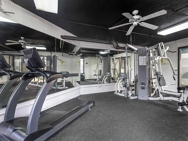 Sweat it out under the cool breeze: Our gym at Independence Plaza keeps you motivated with weights and a refreshing ceiling fan. Your fitness journey starts here!