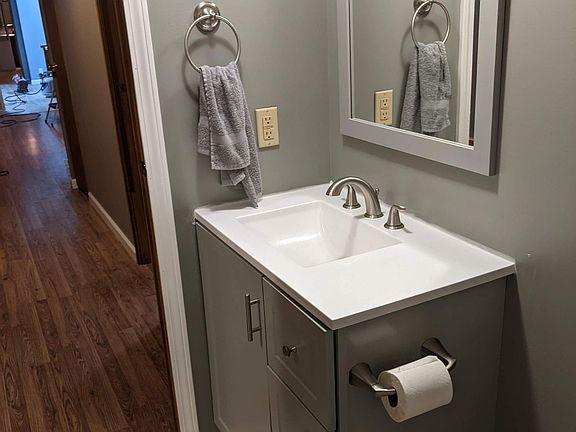 Bathroom at end of unit next to smaller bedrooms. New vanity/mirror.