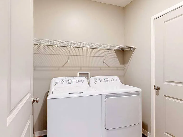 Our one-bedroom Delaney features a dedicated laundry room with a full-sized, side-by-side washer and dryer for ultimate convenience.