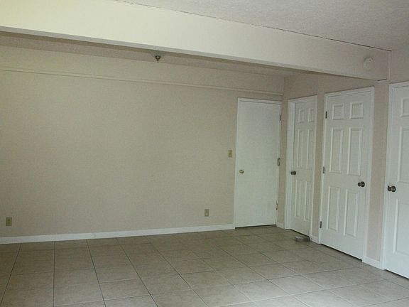 Basement with doors leading to garage, laundry, storage, and