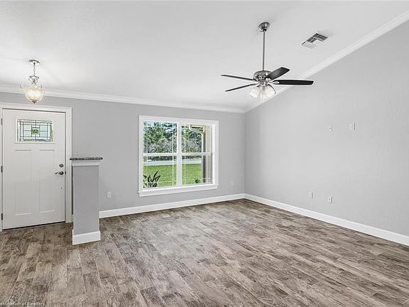 Living Room with wood look plank tile flooring and cathedral ceilings