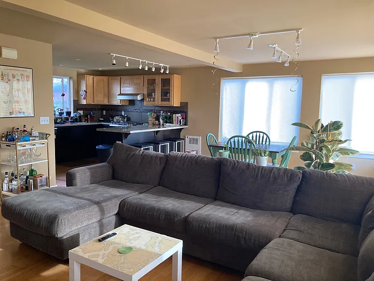 Common area ft. living room, dining and kitchen (featuring couch and dining table)