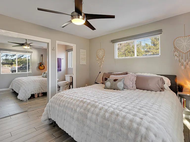 Primary bedroom offering morning sunlight, birdsong, and tranquil views of the mesquite tree