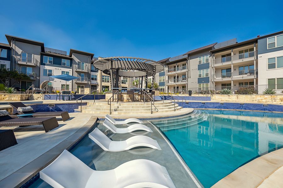 Resort-style pool with tanning shelf