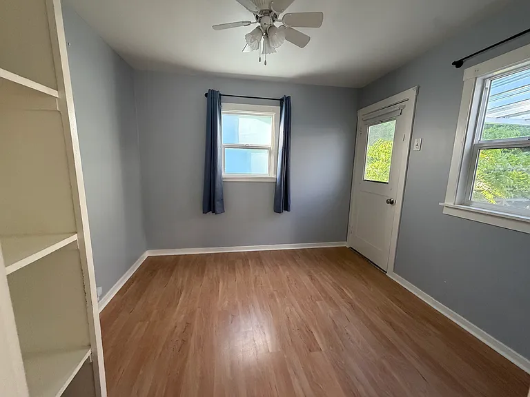 This view of the upstairs bedroom shows the patio door and the plentiful windows. It's hard to show the room size, so look at the furnished photo to get a sense of scale.