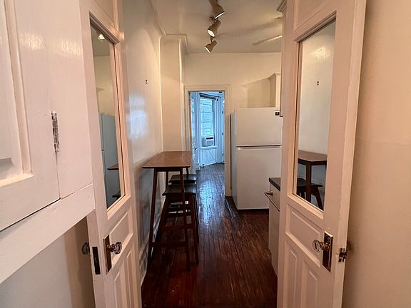 French doors opening to kitchen area