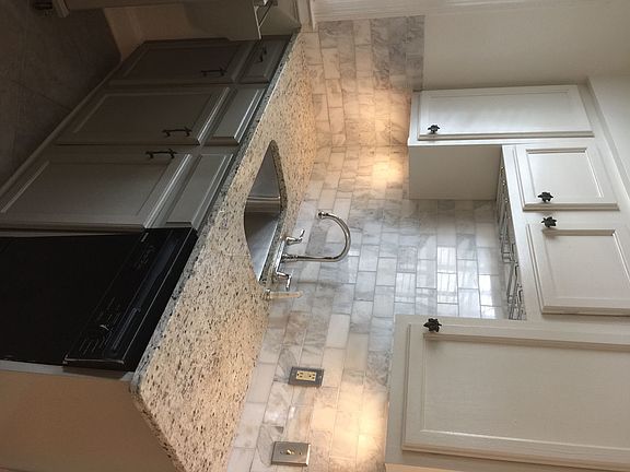 Just renovated kitchen with granite counter tops and marble back splash -undercounted lighting -wine glass rack