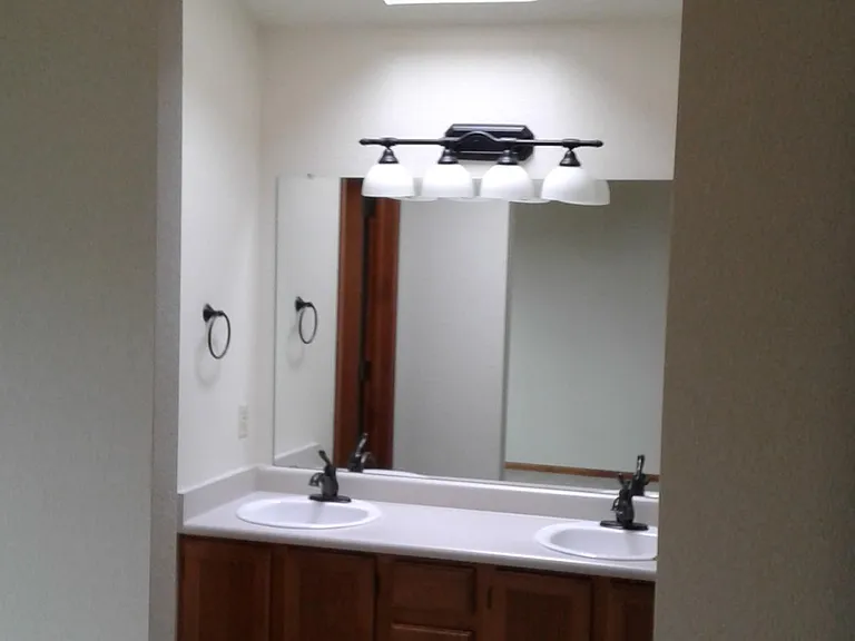 Master bath with updated faucets, light fixtures and double sinks.