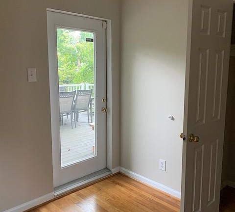 Master bedroom door opens onto side deck. Deck furniture included.