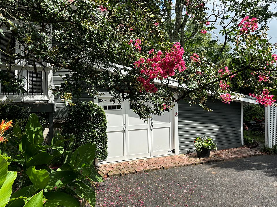 Entrance to private carriage house with balconies off bedroom. Private garden to the right.