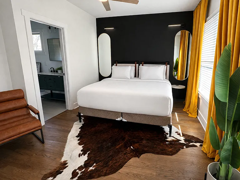 Located on the 2nd floor, the Beltline Suite features plush bedding and luxe linens, bedside charging, blackout curtains, dresser, a ceiling fan, Smart TV, bathroom and deck, all wrapped in thoughtfully curated designer interiors for a stylish stay.