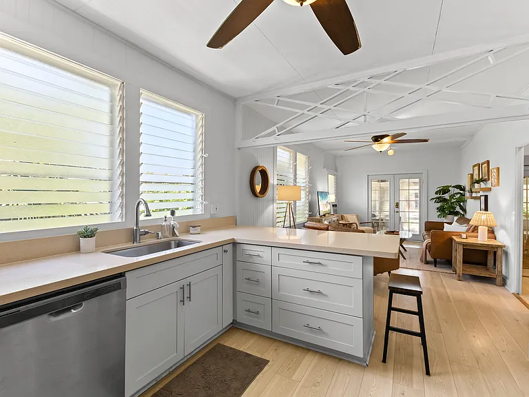 The kitchen is open to the living room and features plenty of storage and counter space, a ceiling fan, full size refrigerator with water station, oven, microwave and dishwasher. The kitchen is fully equipped.
