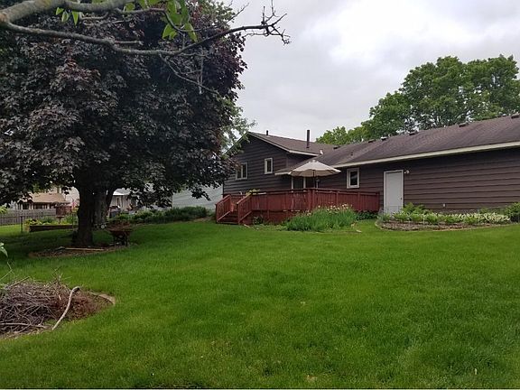 Luscious yard with fire pit.
