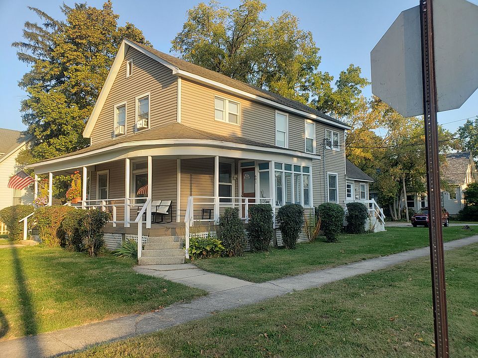 Building with front entrance and porch. Also features the glassed in room. Off street parking is in the back off of the alley.