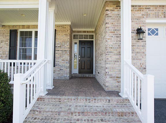 Stamped concrete porch with brick stairs