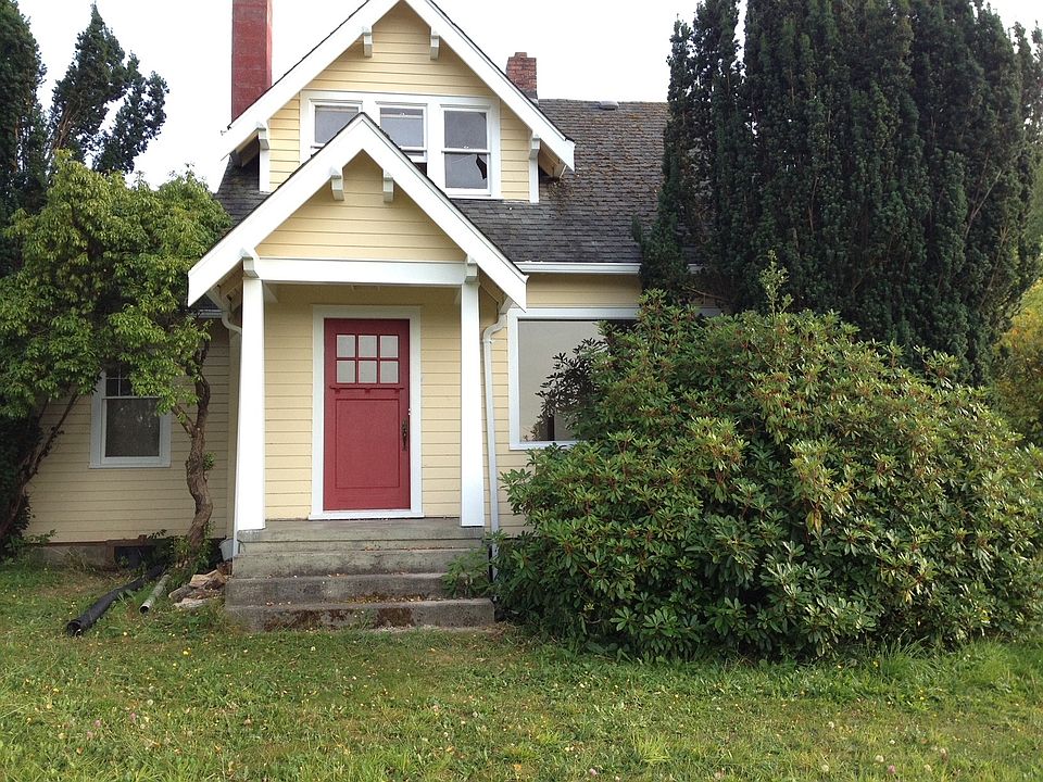 Front Door. The rhododendron bush has been pruned back to open up the view.