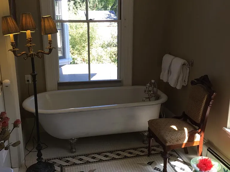 antique 70 inch long tub, pewter feet