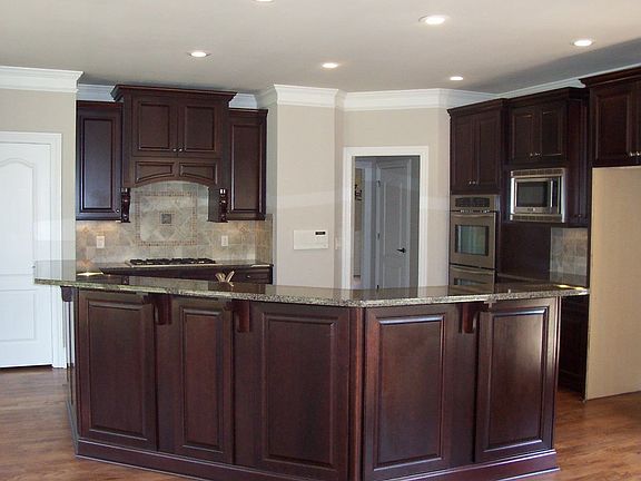 Kitchen with custom cabinetry, granite counters and eat-in center island.