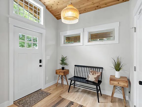 Welcoming stylish entry with warm wood accents