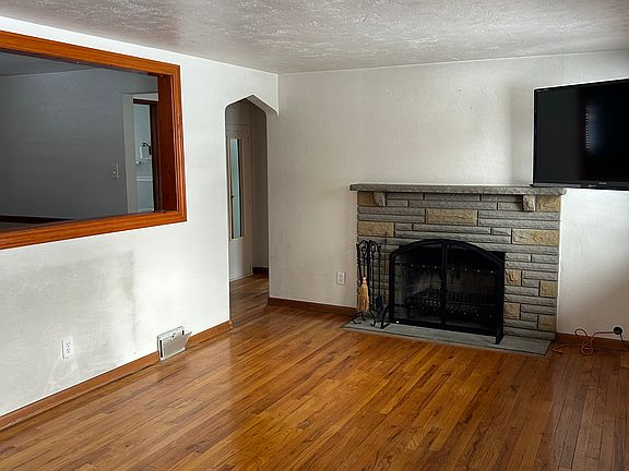 living room with wood burning fireplace