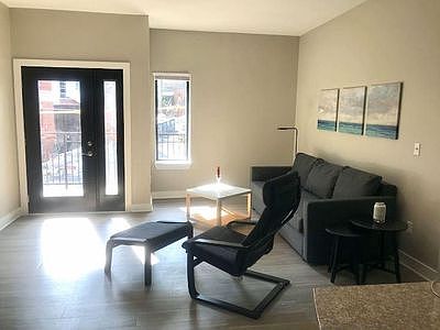 Bright natural light in the family room with access to the balcony.