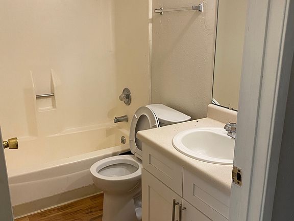 Full bathroom with newer wood, laminate floor.
