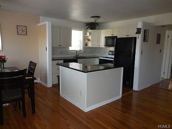 Beautifully remodeled spacious kitchen with granite counters and recessed sink...bright and cheerful...