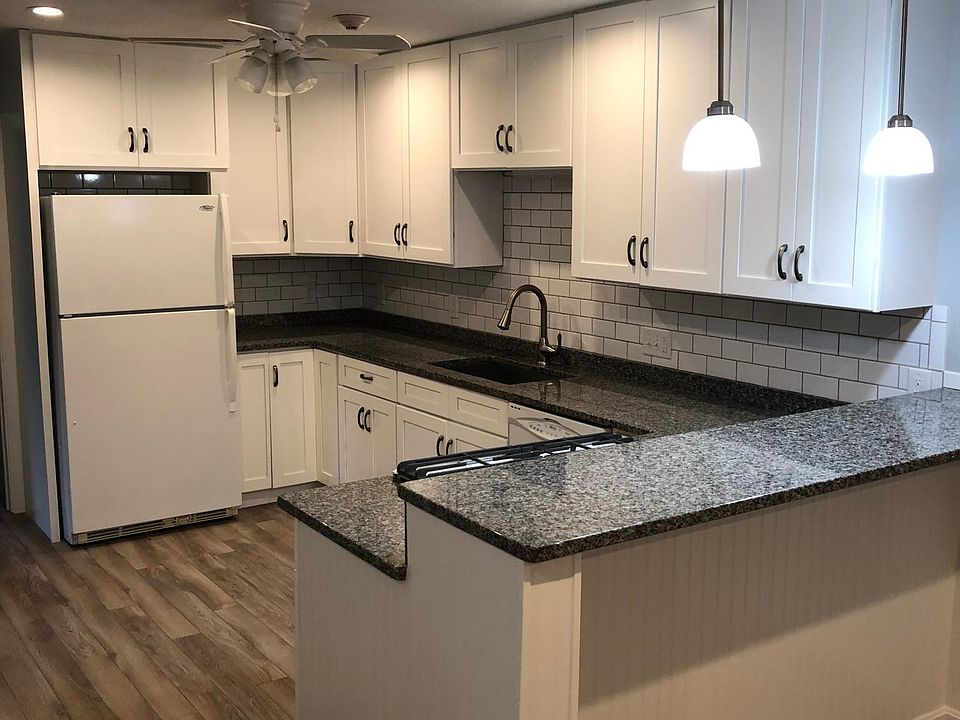 Kitchen with granite countertops and breakfast bar.