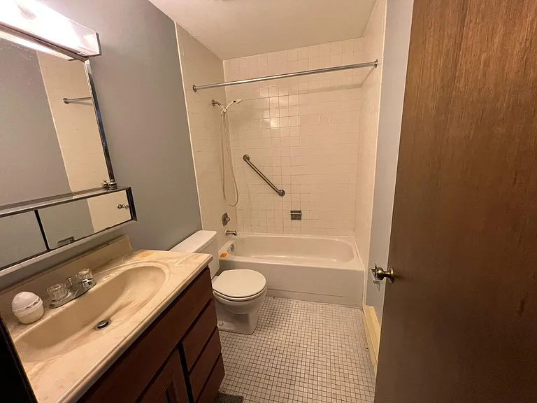 Hallway bathroom with shower and bathtub