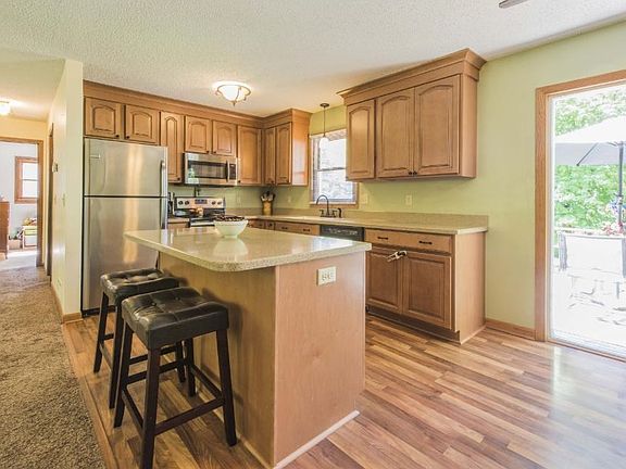 Check out this updated kitchen with new cabinets, stainless appliances, center island and laminate flooring.