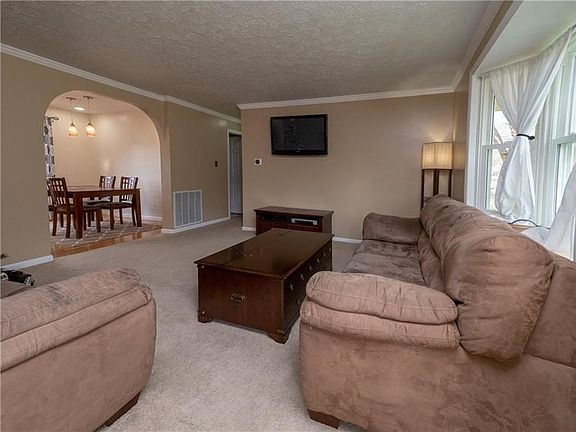 Spacious, neutral and bright family room open to the eat in kitchen.